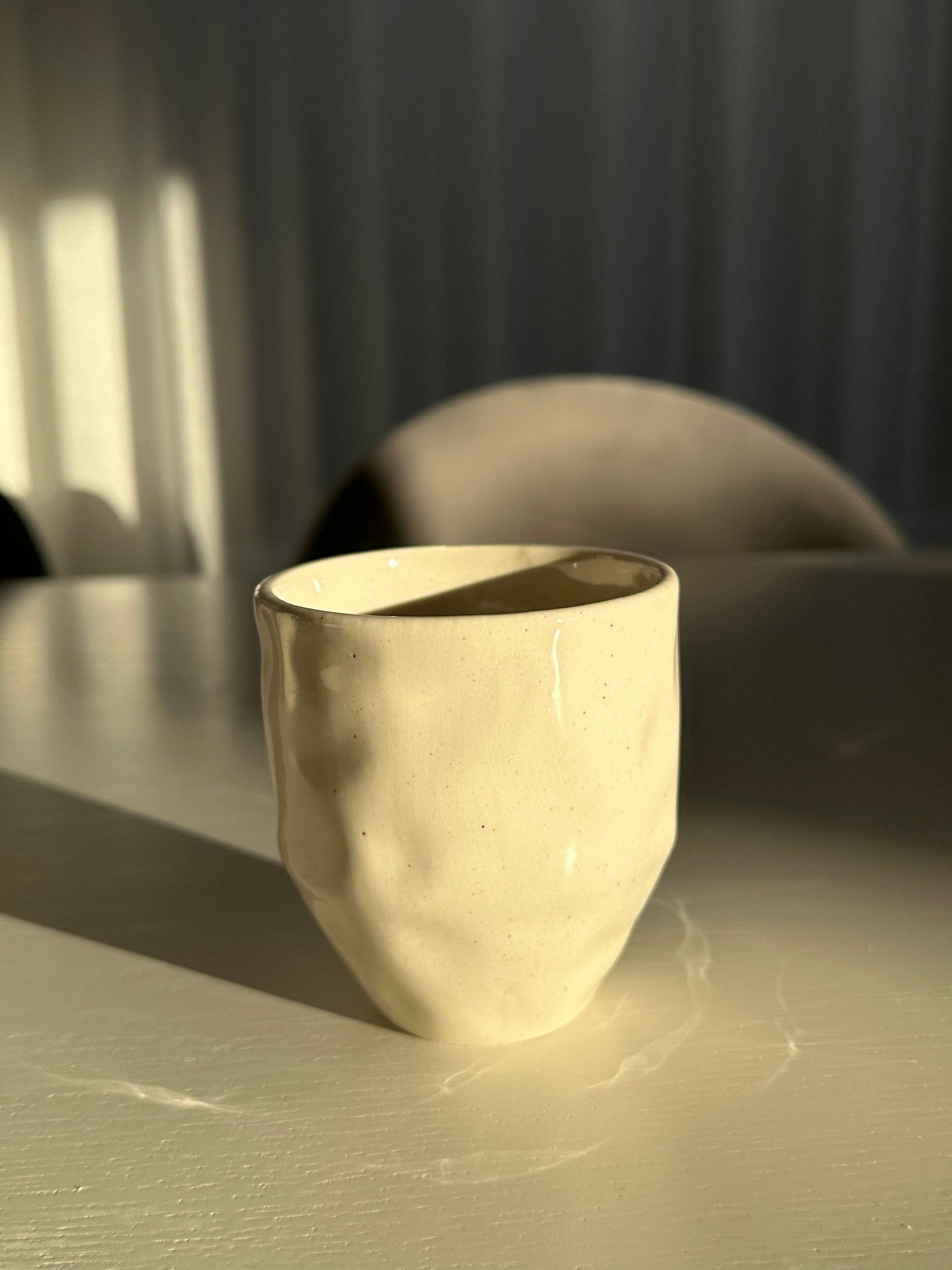 Coffee Cup featuring an organic wabi sabi design - standing up in the morning light