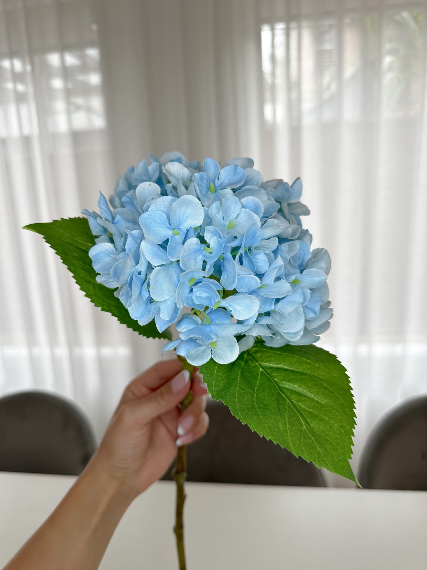 Silk Blue Hydrangea Stem held by hand