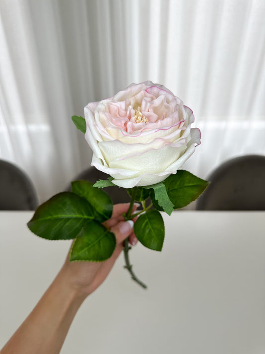 Light Pink Real Touch Singular Peony Stem held by a hand