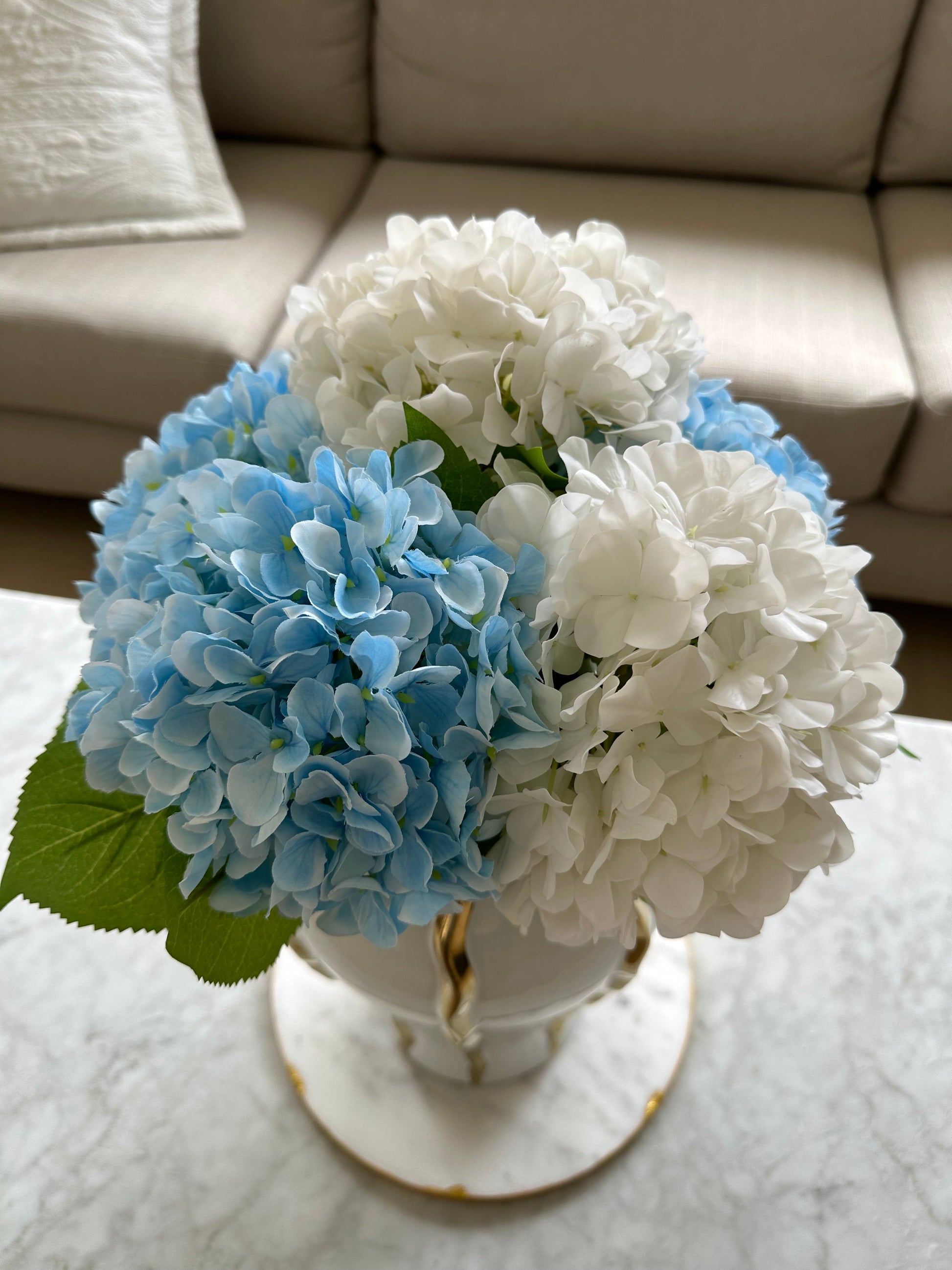 White and Blue Hamptons Style Silk and Real Touch Hydrangeas. On a white and gold vase from top view.